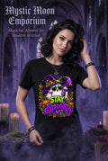 Stay Spooky Halloween t-shirt — black Gildan G200 Ultra Cotton tee with a chill ghost wearing sunglasses and a witch hat, sipping a purple potion against a sparkling full moon, in vibrant purple, green, and orange