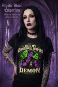 He's My Emotional Support Demon t-shirt — black Gildan G500 Heavy Cotton tee with a purple horned demon wearing a leather vest and ESD (Emotional Support Demon) badge, green moon and bats