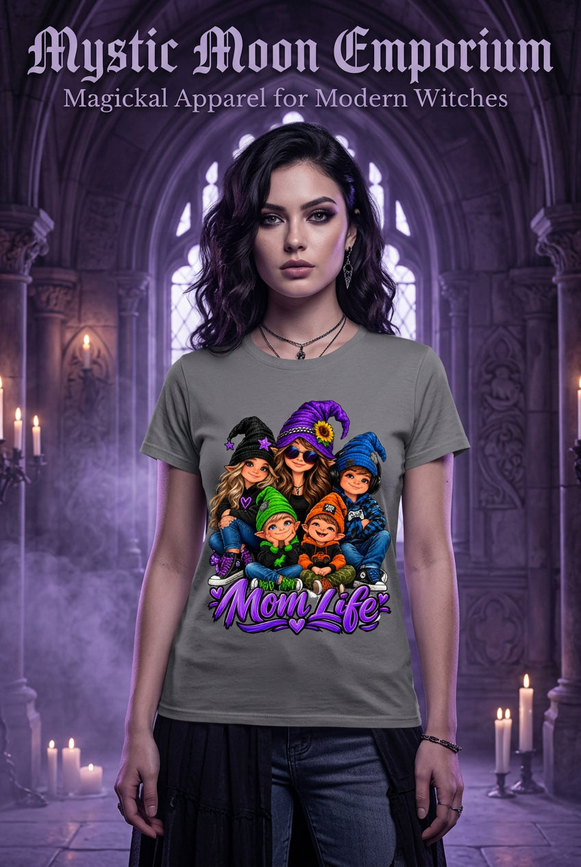 A dark gray crewneck t-shirt featuring a colorful cartoon graphic of five moms in Halloween costumes with the text 'Mom Life' written below in purple stylized lettering.