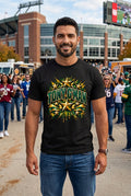  Black Gildan G500 tee with a football flying through a gold goalpost in a packed stadium under bright lights, dark green and gold paint splatter with grass at the bottom on the front, and TONY G'MAN in big dark green varsity letters with gold stars and gold ribbon banners over dark green and gold paint splatter on the back